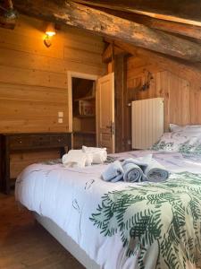 a bedroom with a bed with towels on it at Le Moulin de Bisanne in Villard-sur-Doron