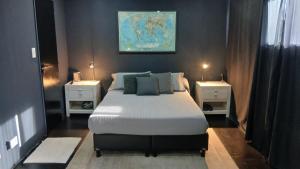 a bedroom with a large bed with two night stands at MiCASA in Córdoba
