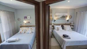 two twin beds in a room with a mirror at Halkidiki Kassandra villa 3P Exclusive Peace & Beautiful Sea Views in Agia Paraskevi