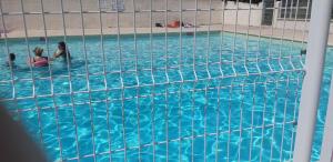 two people swimming in a swimming pool at Mazet du bonheur in Saint-Martin-de-Brômes