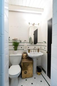 a bathroom with a toilet and a sink at Malibu Surf Cottage on Lechuza Beach in Malibu +23 photos