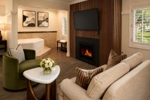 a living room with a couch and a fireplace at Wayside Inn in Carmel