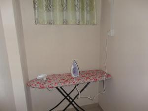 a table with a iron and a fan on it at Abha Villa with Private pool in Galle