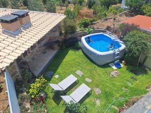 an aerial view of a swimming pool in a yard at O Palheiro - Vista Panorâmica, Jacuzzi e Piscina in Sobreira Formosa