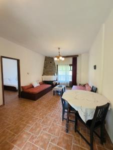 a living room with a table and a couch at Hause Sogambros 2 in Taxiarchis