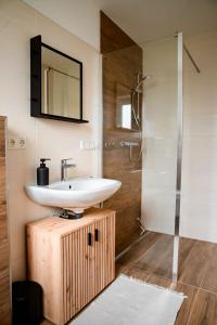 a bathroom with a sink and a shower at Bergblick Zimmervermietung in Ebensee +17 photos