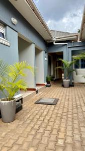 a courtyard of a building with two potted plants at Murchison Close Motel in Masindi