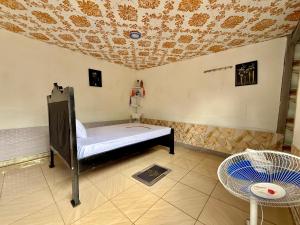 a room with a bed and a table and a chair at Murchison Close Motel in Masindi