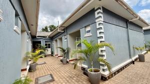 a courtyard of a building with potted plants at Murchison Close Motel in Masindi