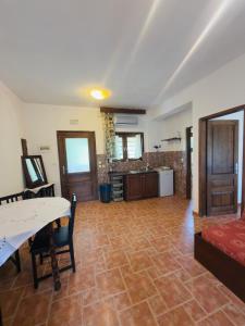 a large living room with a table and a kitchen at Hause Sogambros 2 in Taxiarchis