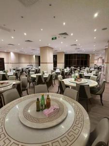 a restaurant with tables and chairs and bottles of wine at الارض المتميزة -1 - نبراس الهدى - Nebras ElHoda in Mecca