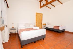 a bedroom with two beds in a room at Hotel Crossman in Puerto Ayora