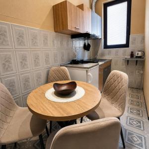 a kitchen with a table with chairs and a bowl on it at Apartments Barocco in Golubac