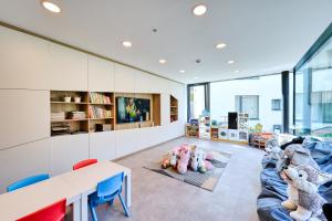 a living room with stuffed animals on a couch at Wellness Hotel Fénix in Liberec
