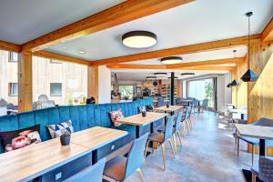 a restaurant with wooden walls and tables and chairs at Wellness Hotel Fénix in Liberec