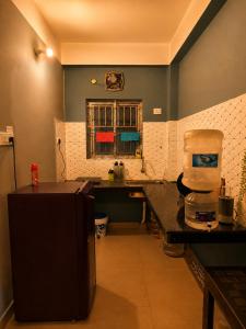 a kitchen with a counter and a window at Elyvia Stays in Guwahati +3 photos