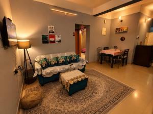 a living room with a couch and a table at Elyvia Stays in Guwahati