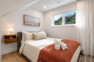 a white teddy bear sitting on a bed in a bedroom at Modern Comfort - Spa - Mountain - Chalet ALBA in Saint Come