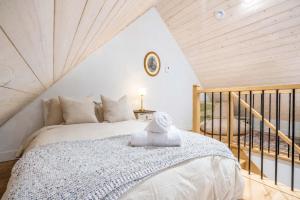 a bedroom with a bed with a towel on it at Modern Comfort - Spa - Mountain - Chalet ALBA in Saint Come +21 photos
