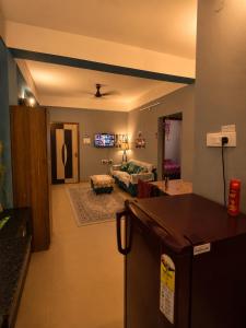 a kitchen and living room with a living room at Elyvia Stays in Guwahati