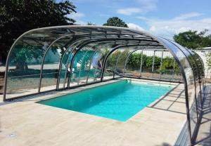 a swimming pool with a metal canopy over a swimming pool at Gästehaus Josef Lang in Andau