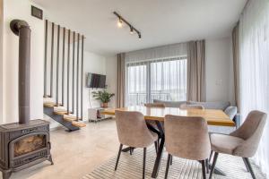 a dining room with a table and a wood stove at Mery House Agroturystyka in Biały Dunajec