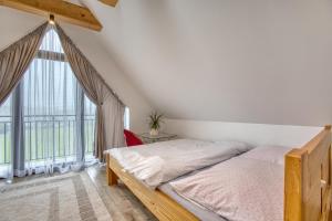 a bedroom with a bed and a large window at Mery House Agroturystyka in Biały Dunajec +28 photos