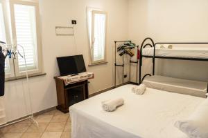 a bedroom with two bunk beds and a television at Villa Sofia in Sogliano Cavour +67 photos