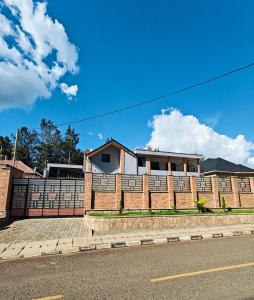 a brick fence in front of a house at Mansarda parkview Hotel in Nyagatare