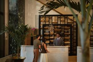 a man and a woman standing in front of a counter at Four Seasons New Orleans in New Orleans +69 photos
