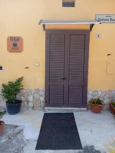 a brown door with a mat in front of a building at Bed And Breakfast ARIS in Benevento