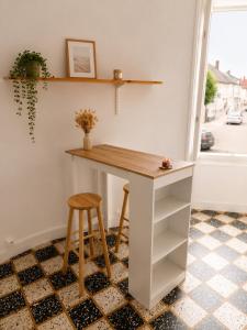 a table and stool in a room with a window at Studio Notre Dame in Château-Chinon