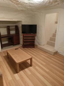 a living room with a tv and a coffee table at Cave Place Units in Coober Pedy