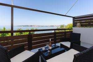a balcony with a view of the ocean at Nimaria Suites in Gialova