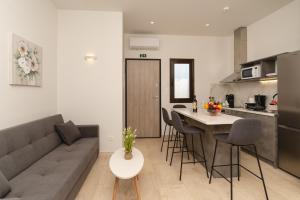 a kitchen and living room with a couch and a table at Nimaria Suites in Gialova