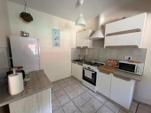 a kitchen with white cabinets and a stove top oven at Agroturystyka ''Dom Pod Karpiem'' in Zagórze Śląskie