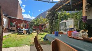 a table with a blue table cloth in a yard at Moon Garden House in Pisac