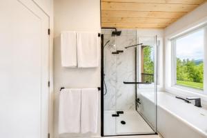 a bathroom with a shower with a glass door at Spa & Foosball - Le WKD in Saint-Philémon
