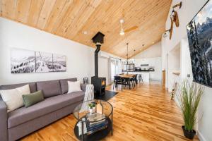 a living room with a couch and a table at Spa & Foosball - Le WKD in Saint-Philémon