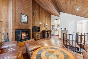 a living room with a couch and a fireplace at Grizzly Den in Whitefish