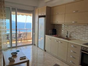 a kitchen with a view of the ocean at Apartment Katherina Sarande in Sarandë