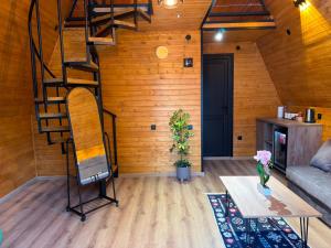 a living room with a spiral staircase in a cabin at Rivendell Vardzia in T'mogvi