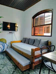 a bed and a couch in a room at Ilha Grande Inn in Abraão