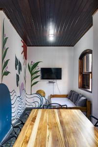 a dining room with a table and a couch at Ilha Grande Inn in Abraão
