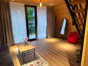 a living room with a couch and a table at Rivendell Vardzia in T'mogvi +40 photos