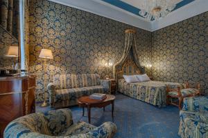 a hotel room with a bed and a couch at Al Ponte Antico in Venice