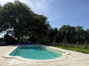 a swimming pool in a yard with trees at Château Talence 1870 in LʼAbsie