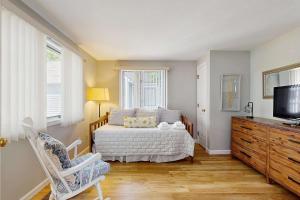 a bedroom with a bed and a television and a dresser at New Seabury Escape in Mashpee +15 photos