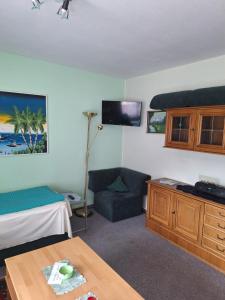 a room with a bed and a couch and a table at Appartement Simone Hofherr in Imst