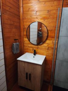 a bathroom with a sink and a mirror at Mike's Lodge Sodwana Bay in Sodwana Bay